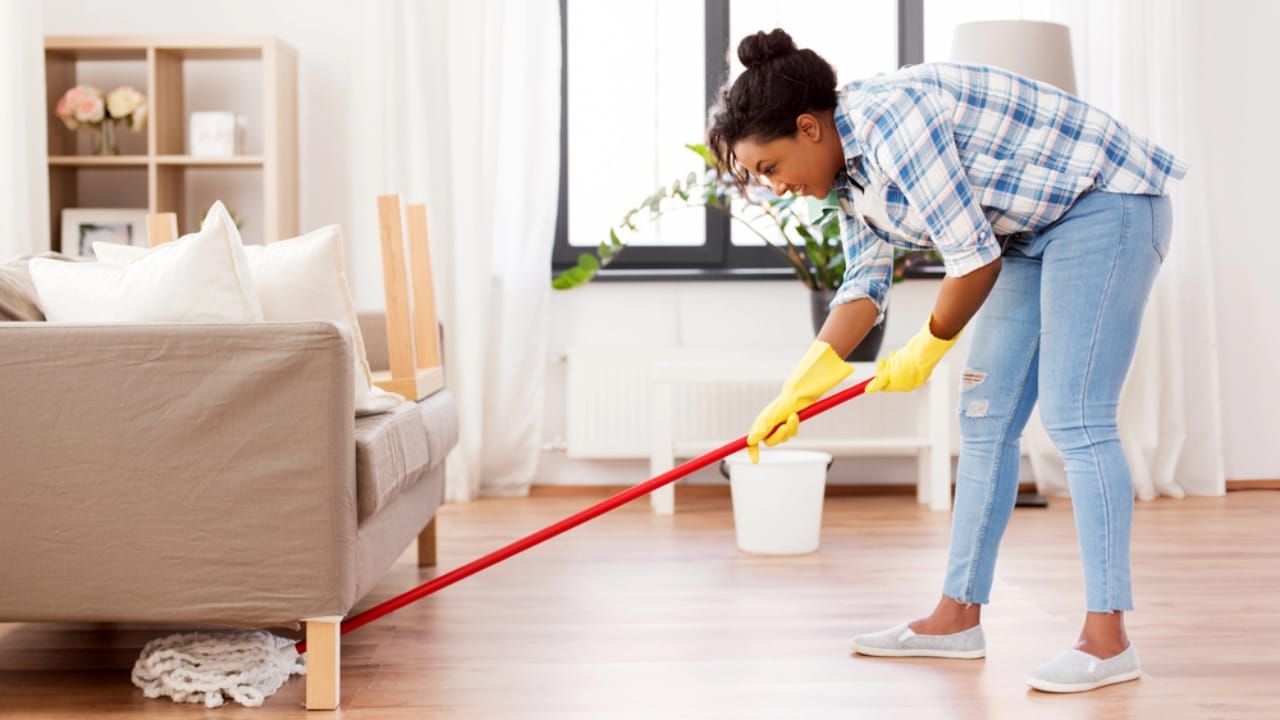 10 Common Cleaning Mistakes That Are Making Your Home Dirtier 8 10 Common Cleaning Mistakes That Are Making Your Home Dirtier - woman cleaning under sofa dp263677272 dnoh