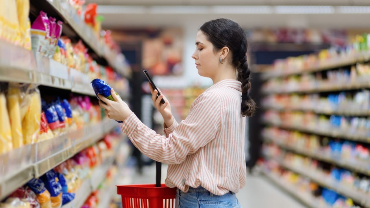 Beat Inflation at the Checkout: 16 Ways to Save on Groceries 14 Beat Inflation at the Checkout: 16 Ways to Save on Groceries - woman scan qr code of product using smartphone dp664856492 dnoh