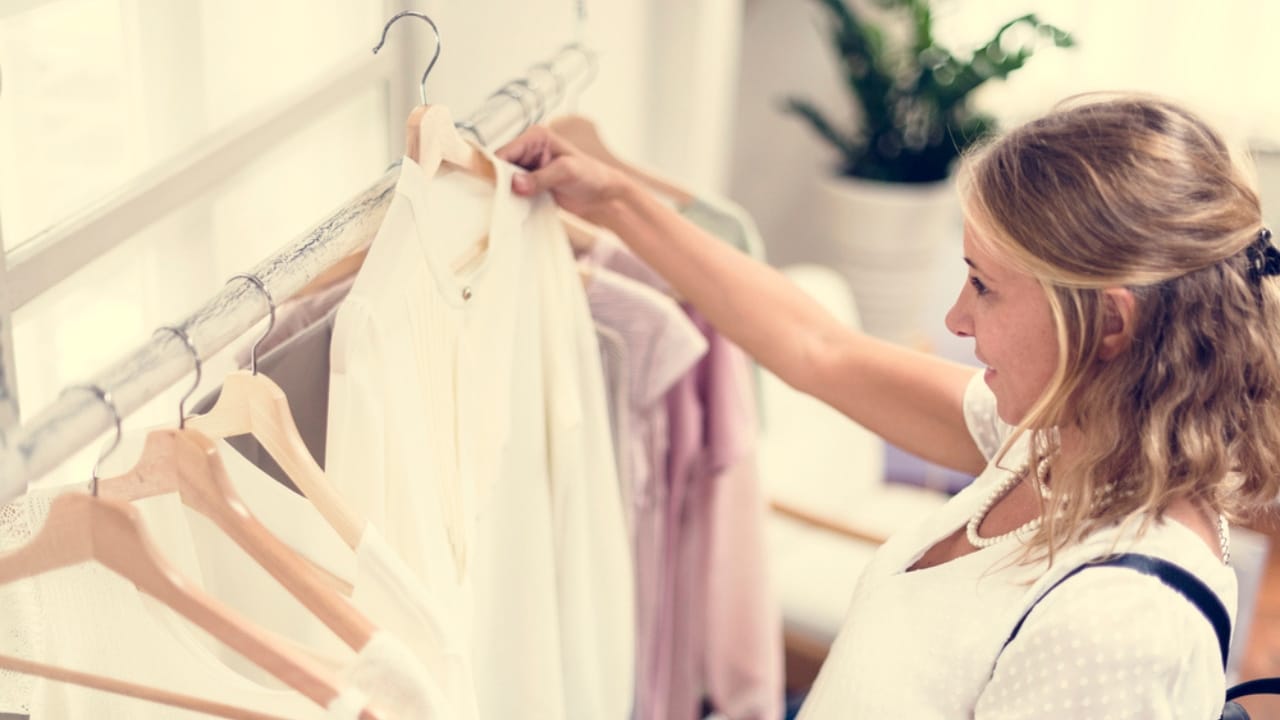 14 Everyday Luxuries Americans Are Cutting to Fight Inflation 9 14 Everyday Luxuries Americans Are Cutting to Fight Inflation - woman shopping clothes dp191745280 dnoh