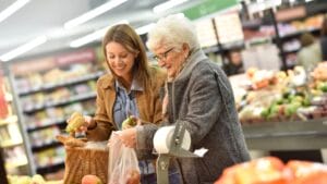 Beat Inflation at the Checkout: 16 Ways to Save on Groceries 1 Beat Inflation at the Checkout: 16 Ways to Save on Groceries - Elderly woman with young woman shopping dp101390616 dnoh