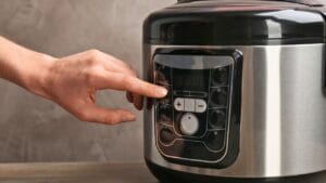 Rethink Your Slow Cooker: 10 Ideas Changing How We Cook 1 Rethink Your Slow Cooker: 10 Ideas Changing How We Cook - Woman turning on modern electric multi cooker ss1349665124 degm