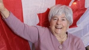 15 Countries Where Life Is Better Than in the U.S. 1 15 Countries Where Life Is Better Than in the U.S. - old woman holding flag of canada dp472410210 dnoh