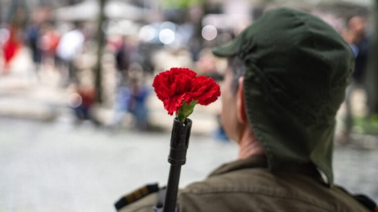 Delicate Blooms Became Powerful Symbols of Defiance 4 Delicate Blooms Became Powerful Symbols of Defiance - soldier celebrating 25th of april ss1338349604 dnoh