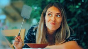 14 Instant Fixes to Keep Flies Away From Your Outdoor Spaces 1 14 Instant Fixes to Keep Flies Away From Your Outdoor Spaces - woman fly Swatter ss2481185681 degm