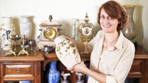 Check Your Home: 15 Things That Could Be Worth a Fortune 1 Check Your Home: 15 Things That Could Be Worth a Fortune - woman holding vintage vase antique collection ss179716349 dpdgm